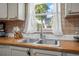 Close-up of a kitchen sink area with tile backsplash, window view, and modern fixtures at 3714 Paige St, Port Orange, FL 32127