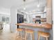 Well-equipped kitchen with breakfast bar, white cabinets, and modern appliances, offering functionality and style at 3714 Paige St, Port Orange, FL 32127