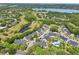 Aerial view showcases an apartment complex, surrounded by golf courses, trees, landscaping and ponds at 3721 S Lake Orlando Pkwy # 05, Orlando, FL 32808