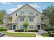 Two-story condo building featuring a light green exterior, symmetrical windows, and landscaped grounds at 3721 S Lake Orlando Pkwy # 05, Orlando, FL 32808