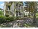 Exterior view of a condo building with stairs leading to the entrance and mature landscaping at 3721 S Lake Orlando Pkwy # 05, Orlando, FL 32808
