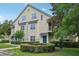Two-story condo building featuring a light green exterior, symmetrical windows, and landscaped grounds at 3721 S Lake Orlando Pkwy # 05, Orlando, FL 32808