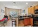 Eat in kitchen with granite countertops, wood cabinets, tile floor and stainless steel dishwasher at 3721 S Lake Orlando Pkwy # 05, Orlando, FL 32808