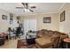 Inviting living room features tile floors, a ceiling fan, and a brown sofa at 3721 S Lake Orlando Pkwy # 05, Orlando, FL 32808