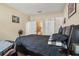 This main bedroom features a dark sleigh bed, wall art and a view to the ensuite bathroom at 3721 S Lake Orlando Pkwy # 05, Orlando, FL 32808