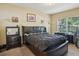 This main bedroom features a dark sleigh bed, desk and a view to the outside at 3721 S Lake Orlando Pkwy # 05, Orlando, FL 32808