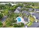 Aerial view of community pool surrounded by palm trees and landscaping, in an apartment complex with mature landscaping at 3721 S Lake Orlando Pkwy # 05, Orlando, FL 32808