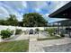 A serene backyard features a gravel patio with outdoor seating and lush landscaping at 4297 Abaco Dr, Tavares, FL 32778