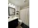 Bathroom featuring a dark vanity, framed mirror, toilet and tub with shower at 4297 Abaco Dr, Tavares, FL 32778