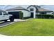 Charming single-story home with a well-manicured lawn and an attached two-car garage at 4297 Abaco Dr, Tavares, FL 32778