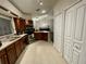 Traditional kitchen with wood cabinets, stainless steel appliances, and tile flooring at 4297 Abaco Dr, Tavares, FL 32778