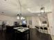 Spacious living room featuring a dining area and adjacent kitchen with a breakfast bar at 4297 Abaco Dr, Tavares, FL 32778