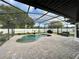 Gorgeous screened-in pool with a stone-paved deck and a well-maintained fenced yard at 4297 Abaco Dr, Tavares, FL 32778
