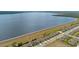 An aerial view shows a neat suburban community adjacent to a lake, offering scenic waterfront living at 455 Lazio Cir, Debary, FL 32713