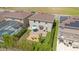 Aerial view of a backyard with a patio, lawn, fire pit and mature landscaping at 455 Lazio Cir, Debary, FL 32713