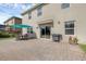 Backyard patio featuring an outdoor dining set, barbeque, and a flower pot at 455 Lazio Cir, Debary, FL 32713
