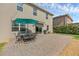 Spacious backyard with a brick patio, outdoor dining set, and lush greenery at 455 Lazio Cir, Debary, FL 32713