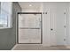 Modern bathroom showcasing a glass-enclosed shower with black trim and white tile surround at 455 Lazio Cir, Debary, FL 32713