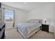 Bright bedroom with a comfortable bed, side tables, and a large window with blinds at 455 Lazio Cir, Debary, FL 32713