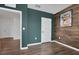 A view of the office space of the bedroom featuring dark green walls, wood floors and paneling at 455 Lazio Cir, Debary, FL 32713