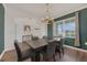 Dining room featuring hardwood floors, neutral colors, a chandelier, and a view of the exterior at 455 Lazio Cir, Debary, FL 32713