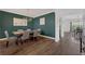 Formal dining room featuring dark green walls, hardwood floors, and stylish chandelier and view to second dining area at 455 Lazio Cir, Debary, FL 32713