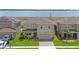 Areal view of a two-story home with an attached two-car garage and manicured lawn at 455 Lazio Cir, Debary, FL 32713