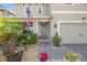 Charming front entrance with landscaped garden and walkway leading to the front door at 455 Lazio Cir, Debary, FL 32713