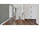 Well-lit hallway leading to various rooms with stylish flooring and neutral paint at 455 Lazio Cir, Debary, FL 32713
