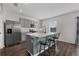 Modern kitchen featuring gray cabinetry, stainless steel appliances, granite countertops, and bar seating at 455 Lazio Cir, Debary, FL 32713