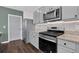 Modern kitchen features stainless steel appliances and grey cabinets at 455 Lazio Cir, Debary, FL 32713