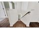 Hardwood stairs featuring white posts and wood railing at 455 Lazio Cir, Debary, FL 32713
