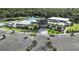 Aerial view of the community clubhouse, highlighting the pool, parking, and surrounding green spaces at 4704 Coral Harbour Rd, Kissimmee, FL 34758