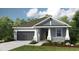 Charming single-story home featuring a two-car garage and a beautifully landscaped front yard at 4704 Coral Harbour Rd, Kissimmee, FL 34758