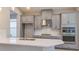 Modern kitchen featuring stainless steel appliances, a spacious island, and stylish cabinetry at 4704 Coral Harbour Rd, Kissimmee, FL 34758