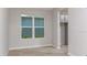 A bright room with wood-look floors and a large window, offering a simple and elegant design at 4704 Coral Harbour Rd, Kissimmee, FL 34758