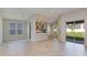 Open-concept living room with hardwood floors and abundant natural light, flowing into the kitchen at 4704 Coral Harbour Rd, Kissimmee, FL 34758