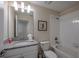 Bright bathroom featuring a granite vanity top, white cabinets, and a shower-tub combo at 4807 Kings Castle Cir, Kissimmee, FL 34746