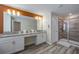 Stylish bathroom featuring double sinks, vanity, and large tiled shower at 4807 Kings Castle Cir, Kissimmee, FL 34746