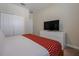 Simple bedroom with a large TV and closet at 4807 Kings Castle Cir, Kissimmee, FL 34746