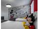 A bedroom featuring Mickey Mouse wallpaper and decor at 4807 Kings Castle Cir, Kissimmee, FL 34746