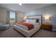 Well-lit bedroom with a large bed, and nightstands with warm lamps at 4807 Kings Castle Cir, Kissimmee, FL 34746