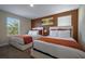 Comfortable bedroom featuring two beds, colorful art, and large windows at 4807 Kings Castle Cir, Kissimmee, FL 34746