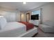 Cozy bedroom features a large bed, dresser with TV, and comfortable seating at 4807 Kings Castle Cir, Kissimmee, FL 34746