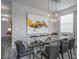 Elegant dining area featuring contemporary lighting, a glass table, and stylish decor at 4807 Kings Castle Cir, Kissimmee, FL 34746