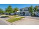 View of the lovely gray townhomes that have manicured lawns and elegant tree lined streets at 4807 Kings Castle Cir, Kissimmee, FL 34746