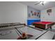 Spacious game room featuring an air hockey table, pool table, and fun decor at 4807 Kings Castle Cir, Kissimmee, FL 34746