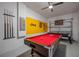 Pool table with cues and billiard balls in a game room with baseball decor at 4807 Kings Castle Cir, Kissimmee, FL 34746