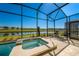 Relaxing screened-in hot tub with views of the pond and community at 4807 Kings Castle Cir, Kissimmee, FL 34746