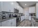 Modern kitchen boasts granite counters, stainless appliances, mosaic backsplash, and ample cabinet space at 4807 Kings Castle Cir, Kissimmee, FL 34746